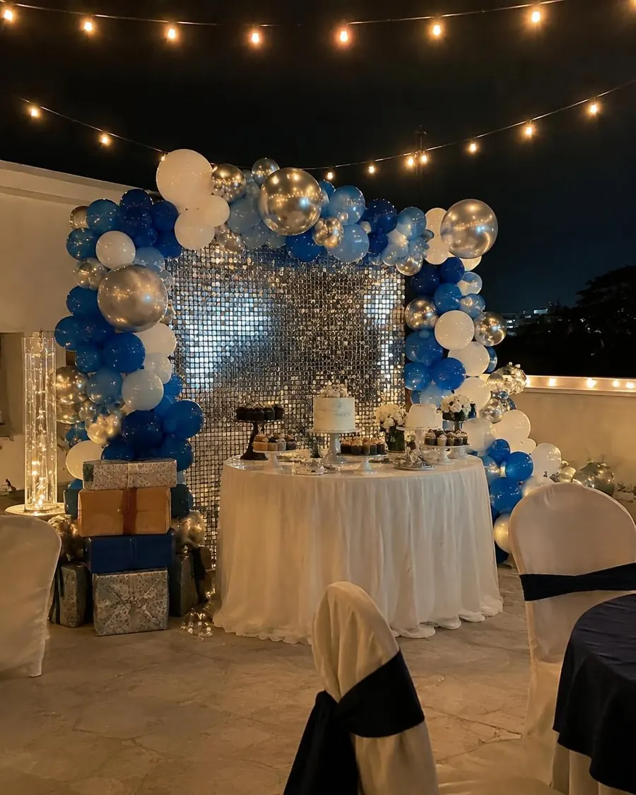 Blue, white and silver balloon backdrop with shimmer wall and dessert table