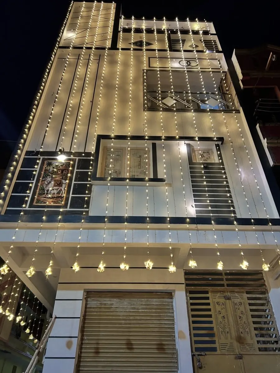 Wedding house front decorated with string lights at night by Raju Tent & Catering Services, Bilaspur