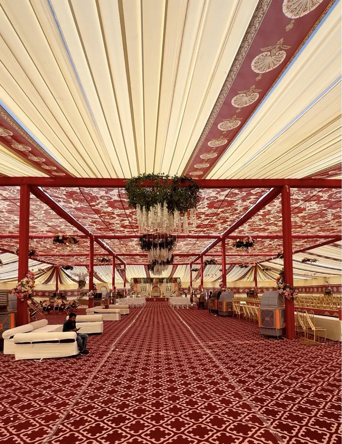 Large wedding pandal with printed fabric ceiling, red frame, sofas and coolers by Raju Tent & Catering Services, Bilaspur